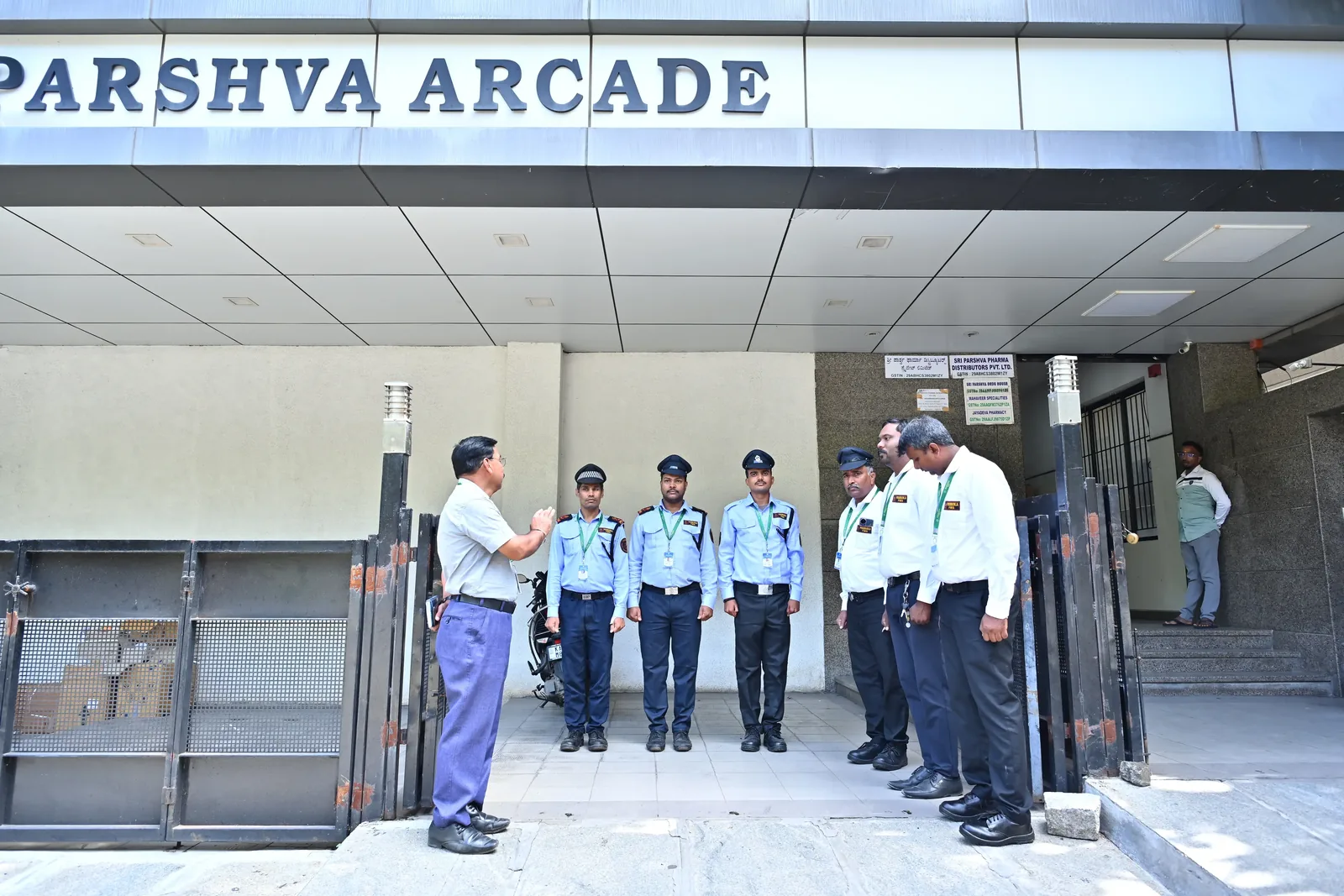 Poorvika FMS guards on duty at a commercial arcade entrance